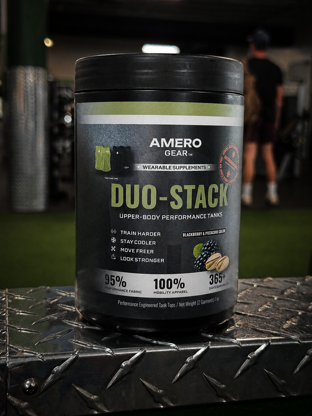 Amero Gear Duo-Stack supplement container on a metallic surface with a blurred background