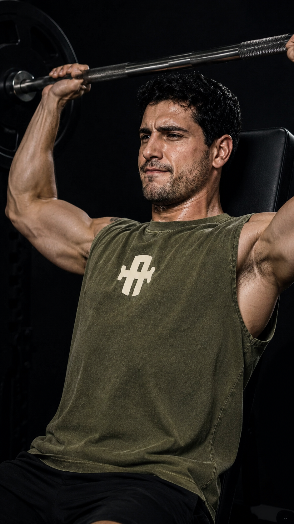 Man lifting weights with a dark background