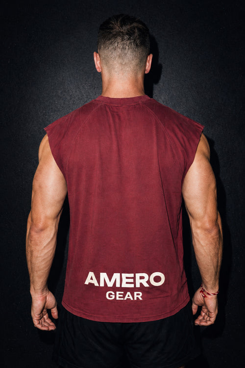 Man wearing a maroon sleeveless shirt with 'Amero Gear' branding on a black background