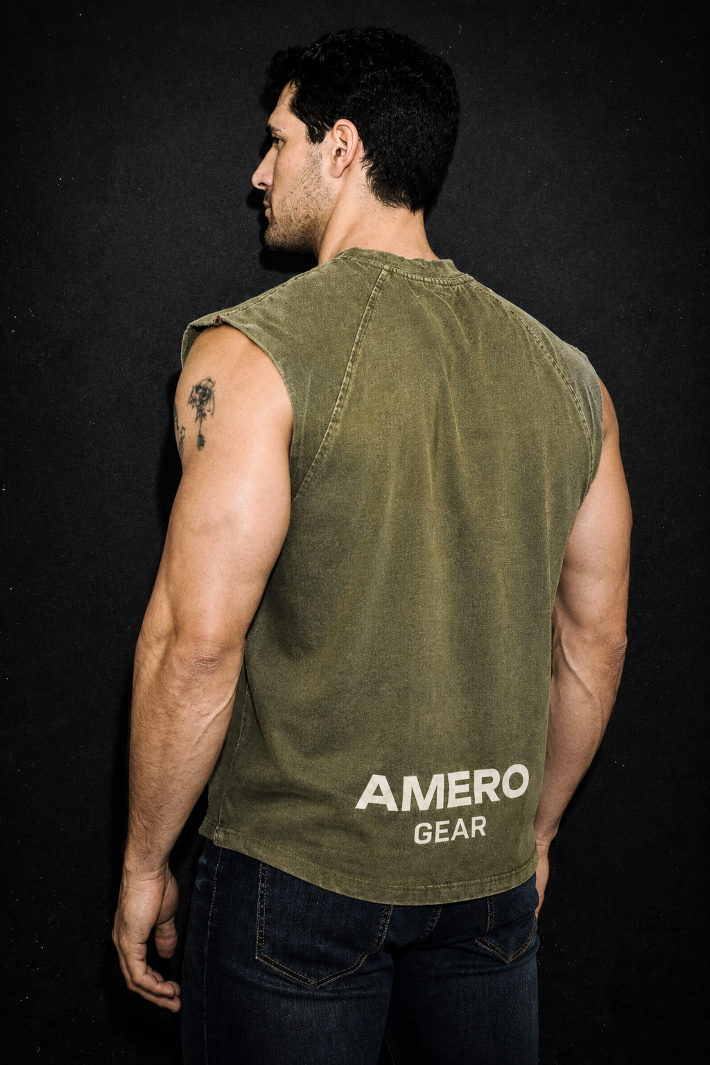 Man wearing a green sleeveless shirt with 'AMERO GEAR' branding on a black background