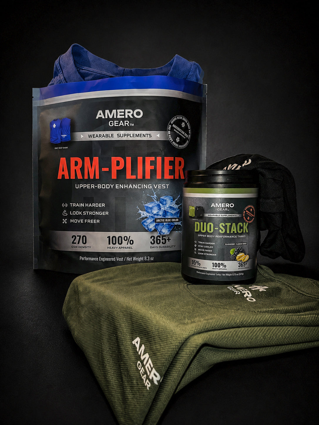 A product bundle from Amero Gear on a dark studio background, featuring a blue and black 'Arm-Plifier' wearable supplement pouch, a black 'Duo-Stack' powder tub, and an olive green branded sweatshirt draped over a dark surface.