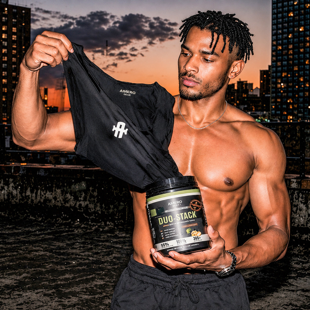 Muscular man holding a black sleeve and a container labeled 'DUO STACK' against a cityscape background.